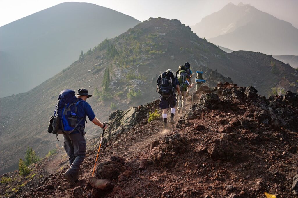 Essential Hiking Gear: Trekking typically involves longer journeys through remote and rugged terrain